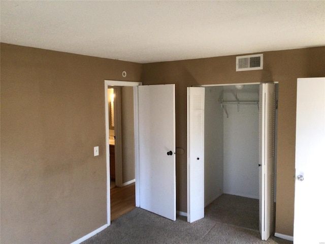 unfurnished bedroom featuring carpet floors and a closet