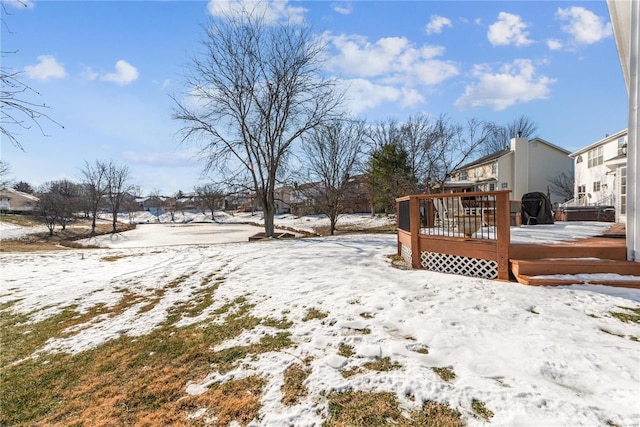 yard covered in snow with a wooden deck