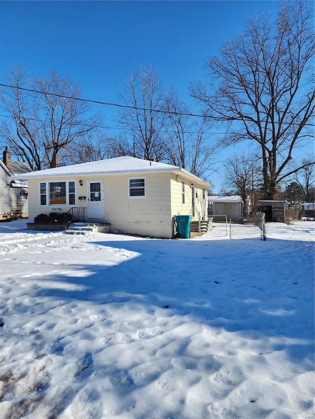 view of snow covered back of property