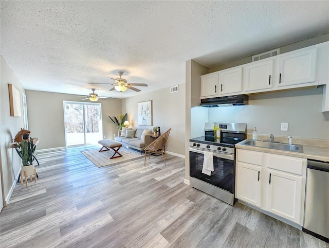 kitchen with appliances with stainless steel finishes, light hardwood / wood-style floors, sink, and white cabinets