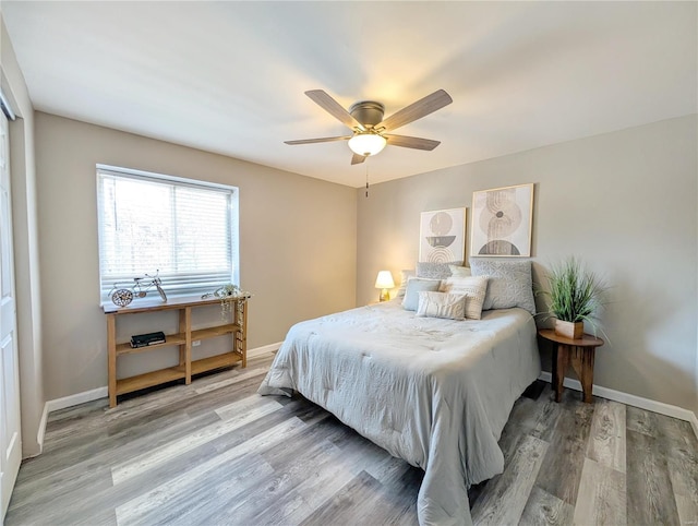 bedroom with hardwood / wood-style floors and ceiling fan