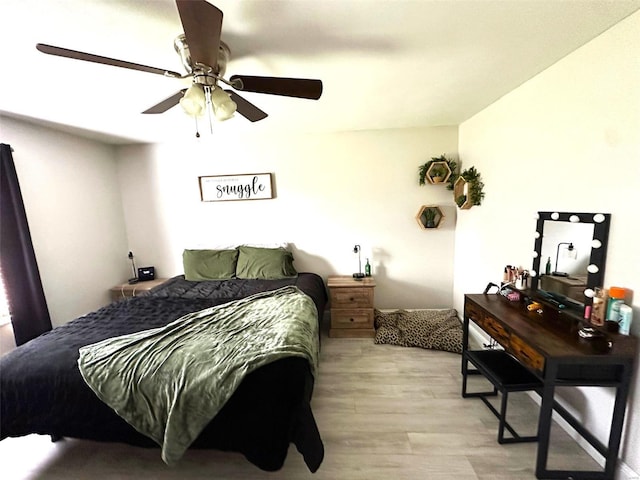 bedroom with ceiling fan and light hardwood / wood-style floors