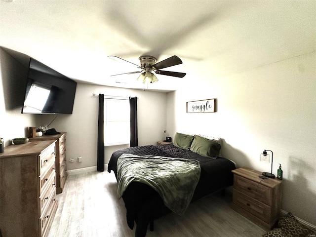 bedroom with ceiling fan and light hardwood / wood-style flooring