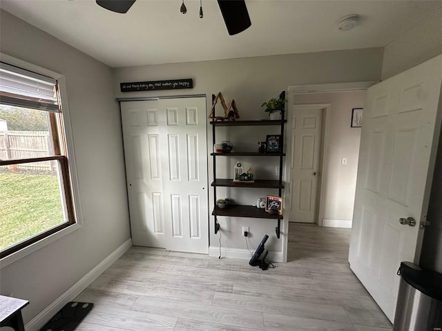 unfurnished bedroom featuring ceiling fan, light hardwood / wood-style floors, and a closet