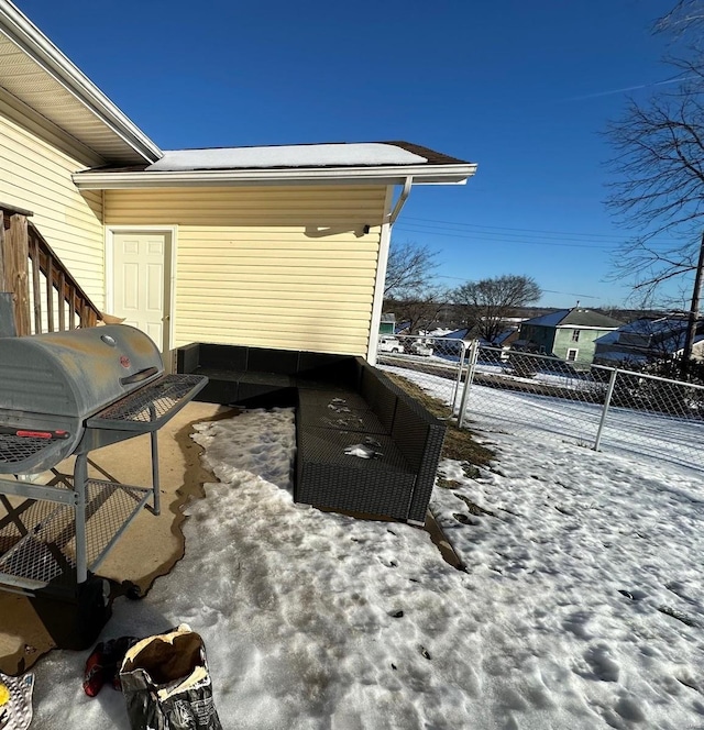 snow covered patio with area for grilling