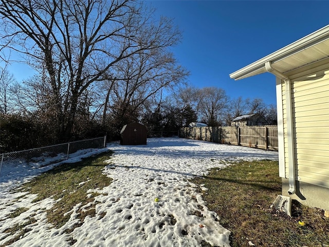 snowy yard with a storage unit