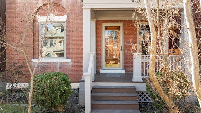 property entrance featuring brick siding