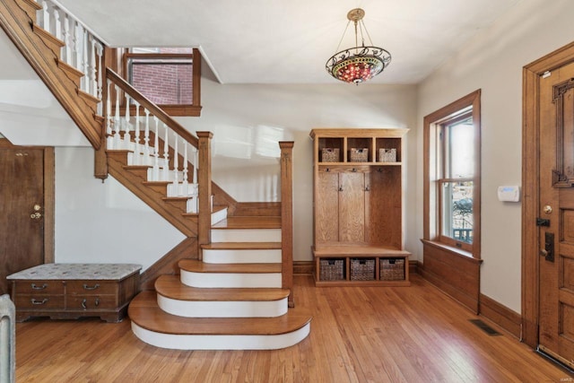 mudroom featuring hardwood / wood-style floors, baseboards, and visible vents