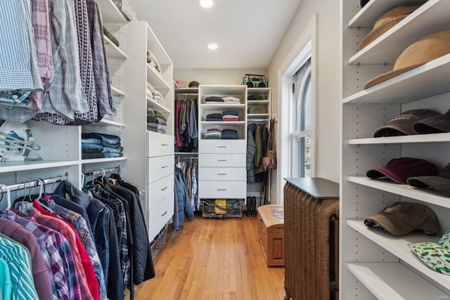 walk in closet with light wood-style floors