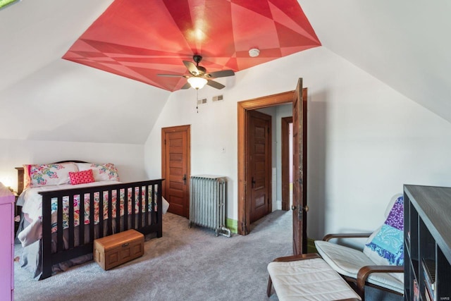 bedroom with visible vents, radiator heating unit, carpet flooring, ceiling fan, and vaulted ceiling