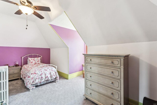 carpeted bedroom with baseboards, lofted ceiling, ceiling fan, and radiator heating unit