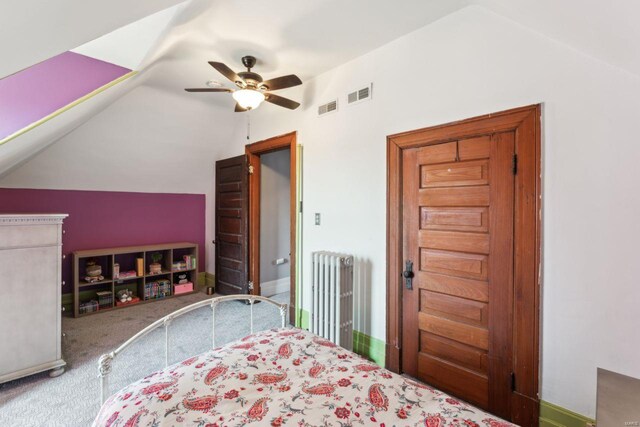 bedroom with carpet flooring, vaulted ceiling, radiator heating unit, and visible vents