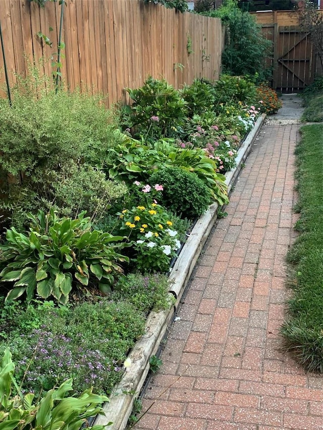 exterior space featuring a vegetable garden and fence