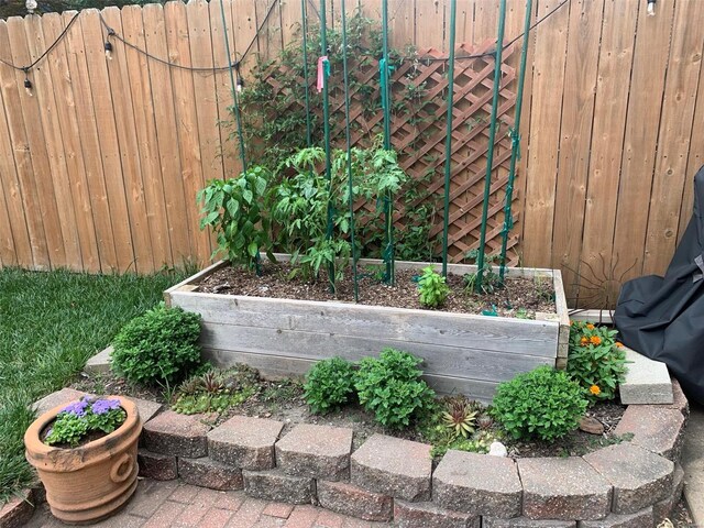 exterior details with a vegetable garden and fence