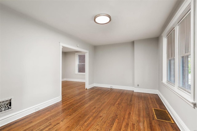 spare room with wood-type flooring