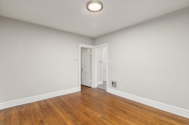 unfurnished room with dark hardwood / wood-style floors