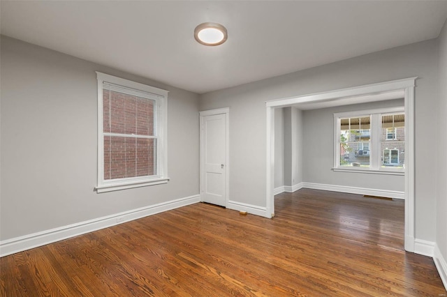 spare room featuring dark hardwood / wood-style floors