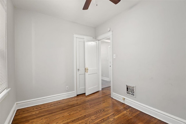 empty room featuring ceiling fan and dark hardwood / wood-style floors