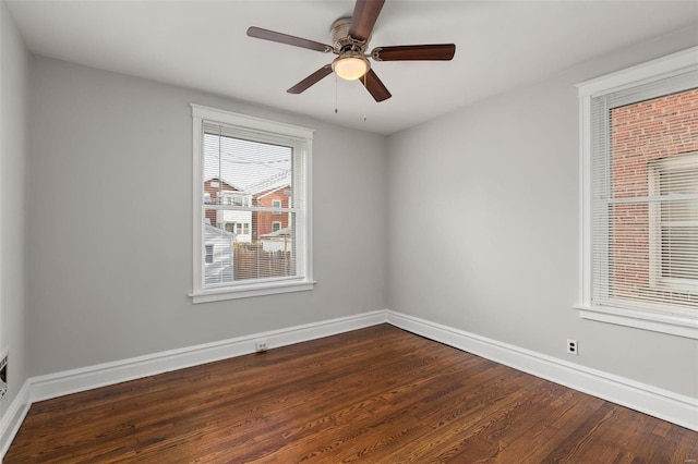 spare room with ceiling fan and dark wood-type flooring