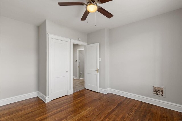 unfurnished bedroom featuring ceiling fan and dark wood-type flooring