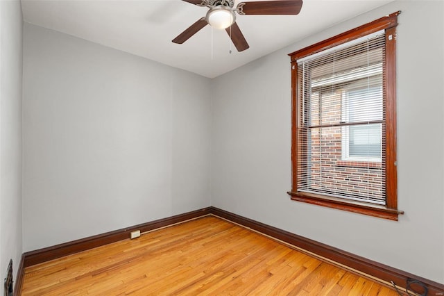 empty room with ceiling fan and light hardwood / wood-style flooring