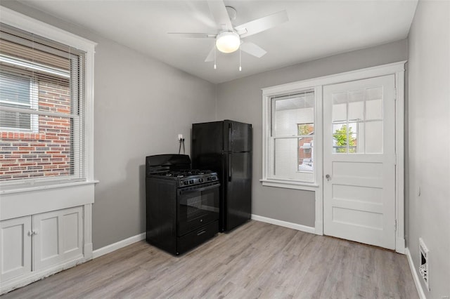 kitchen featuring black appliances, ceiling fan, and light hardwood / wood-style flooring