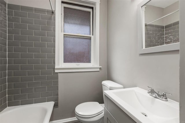 full bathroom with toilet, vanity, tiled shower / bath combo, and plenty of natural light