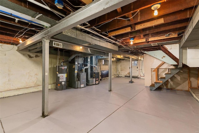 basement featuring heating unit and water heater