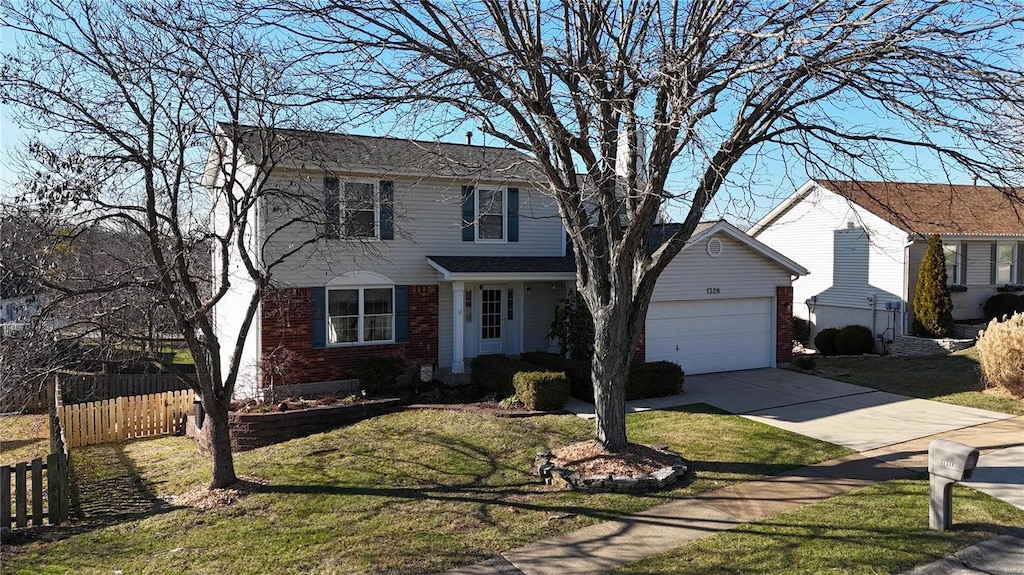 view of front of property with a garage and a front yard