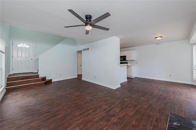 unfurnished living room with dark wood-type flooring and ceiling fan