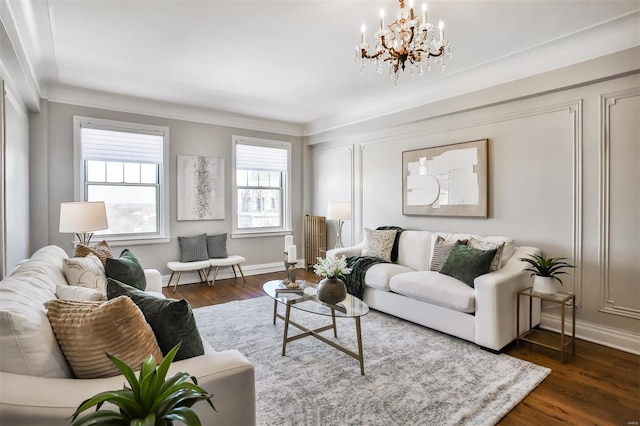 living room featuring dark wood-type flooring, radiator heating unit, crown molding, and a chandelier