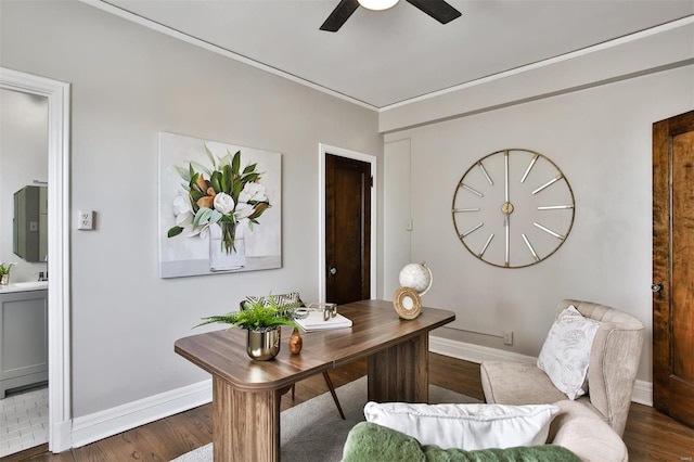 office space featuring wood finished floors, a ceiling fan, baseboards, ornamental molding, and electric panel