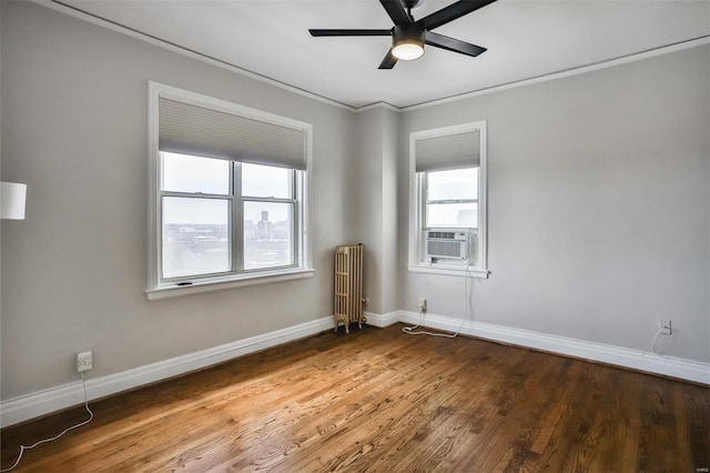 unfurnished room with radiator, hardwood / wood-style flooring, ceiling fan, cooling unit, and ornamental molding