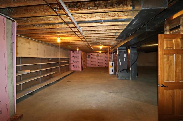 basement featuring water heater and heating unit