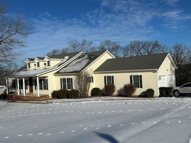 view of front of property featuring a garage and a porch