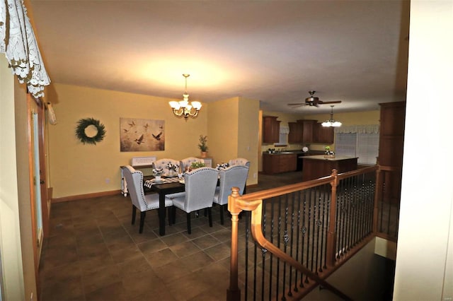 dining area featuring ceiling fan with notable chandelier