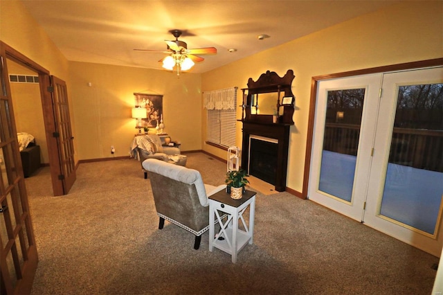 living room featuring ceiling fan and carpet flooring