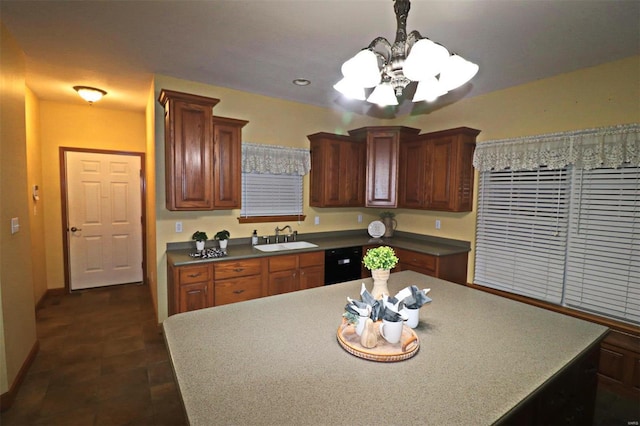 kitchen featuring hanging light fixtures, dishwasher, sink, and a chandelier