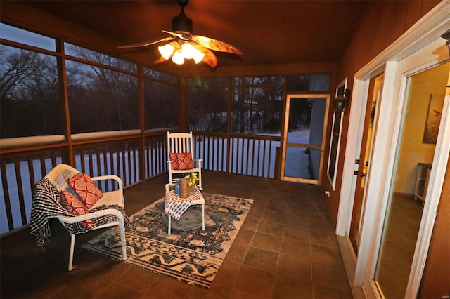 sunroom featuring ceiling fan