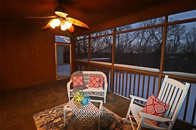 unfurnished sunroom with ceiling fan