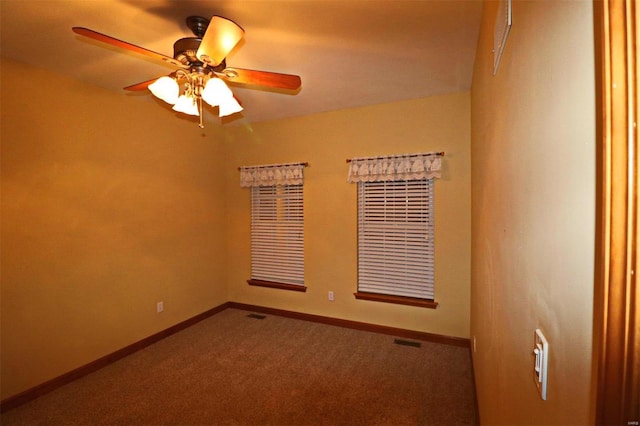 spare room featuring ceiling fan and carpet flooring