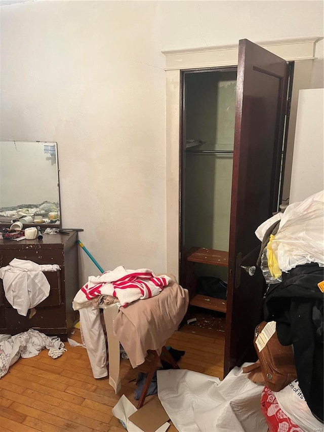 bedroom with wood-type flooring and a closet