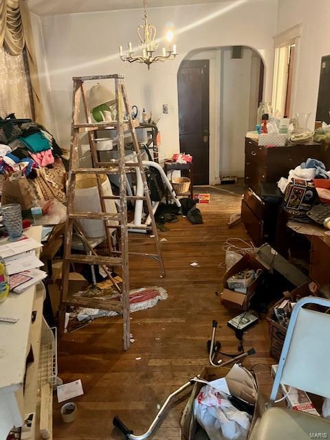 miscellaneous room with an inviting chandelier and hardwood / wood-style floors