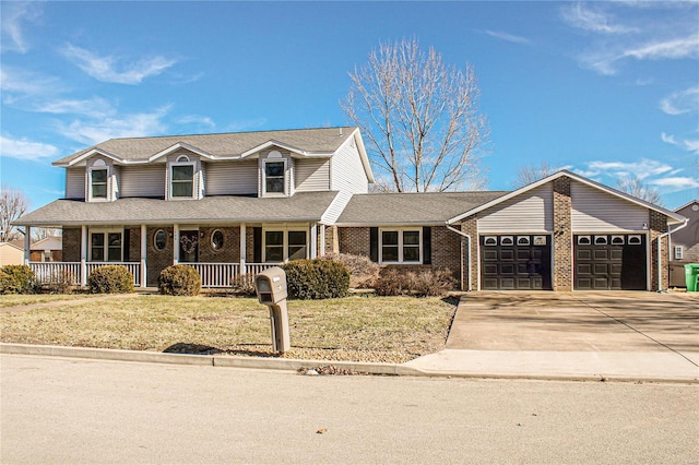 view of front of home with a garage, a front yard, and a porch