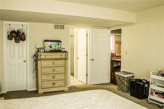 carpeted bedroom with a textured ceiling