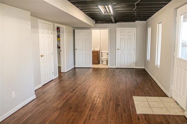 interior space with connected bathroom and dark hardwood / wood-style flooring