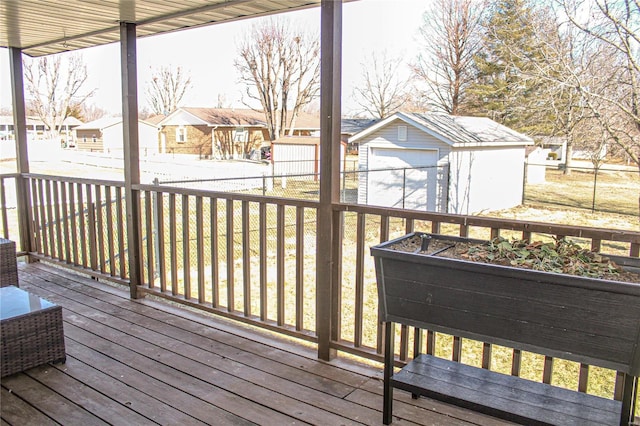 wooden terrace with a garage and an outdoor structure