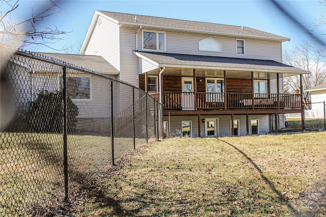 rear view of property featuring a yard