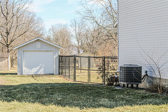 view of yard with cooling unit, a garage, and an outbuilding