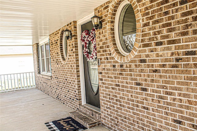 view of exterior entry with covered porch